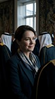 Professional middle-aged Caucasian businesswoman in elegant navy blazer and silk scarf sitting confidently in luxury hotel or conference room interior.