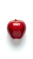 Fresh red apple with water droplets isolated on white background, suitable for food, nutrition, and healthy eating designs.