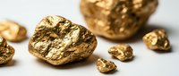 Raw gold nuggets and precious metal chunks scattered on white background for mining industry and investment concepts.