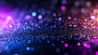 Glowing purple and blue sparkles on dark background with bokeh effect and shallow depth of field create magical atmosphere for festive designs.
