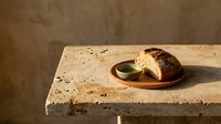 Minimalist composition featuring a ceramic cup with hot beverage on a textured stone surface against neutral background, suitable for lifestyle and wellness design projects.