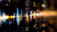 Financial market data visualization showing blue and orange glowing candlestick charts and digital indicators on dark background with bokeh effect.