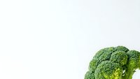 Fresh green broccoli head isolated on white background for healthy eating and nutrition concepts, cooking ingredients and vegetable designs.