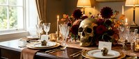 Halloween dining room table setting with skull centerpiece surrounded by autumn flowers and foliage. Elegant spooky dinner party decor for seasonal entertaining.
