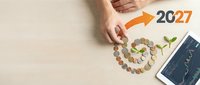 Hands arranging coins in spiral pattern with green plant sprout and 2027 text, symbolizing financial growth and investment planning for future success.