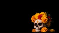Decorative skull with traditional Day of Dead makeup adorned with bright orange marigold flowers on black background, Mexican culture celebration symbol.