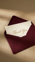 Elegant thank you card with gold script lettering in a deep burgundy envelope on a warm beige background, perfect for gratitude and celebration concepts.