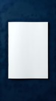 Blank white paper sheet on dark navy blue textured background, minimalist mockup for branding, print design, and stationery presentation.