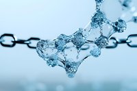 Frozen water droplets forming delicate crystalline chain structures against light blue background, showcasing natural ice formations and winter macro photography.