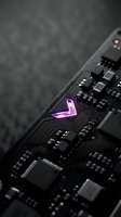 Modern computer motherboard with glowing purple circuit pattern and electronic components on dark background for technology and hardware concepts.