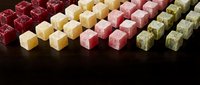 Colorful Turkish delight candy cubes arranged in rows on dark background, traditional Middle Eastern sweets confectionery dessert for culinary and food photography.