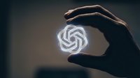 Hand holding glowing geometric neon symbol representing artificial intelligence, technology innovation, and digital transformation for business and tech concepts.
