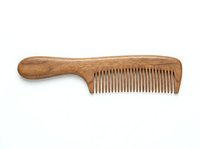 Wooden hair comb with handle isolated on white background, ready for haircare product design, beauty packaging, and grooming retail applications.