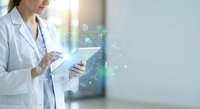 Female doctor in white coat using digital tablet with holographic medical data interface displaying health analytics and patient information in modern clinic.