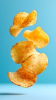 Crispy potato chips floating in air against bright blue background, creating dynamic composition for food advertising and snack packaging design.