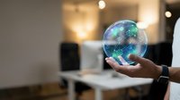 Hands holding glowing crystal sphere with digital network particles and light effects, representing innovation, technology, and future business solutions.