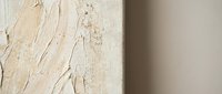 Textured beige canvas with thick impasto paint strokes creating abstract relief surface for modern interior design and artistic wall decoration.