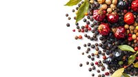 Fresh colorful peppercorns mix with red, black, and white varieties scattered with bay leaves and dried berries on white background, culinary spice concept.