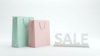 Pastel mint and pink shopping bags beside a white SALE sign on a light background, perfect for retail promotions and seasonal discount campaigns.