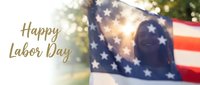 Happy Labor Day celebration with American flag and sunlight creating patriotic atmosphere for national holiday greeting card and social media posts.