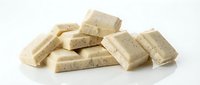 White chocolate bars with nuts scattered on white background, isolated for packaging design and food advertising.