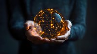 Glowing golden sphere with network connections floating between hands against dark background, representing global technology and digital transformation.