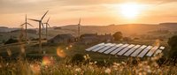 Wind turbines and solar panels in rural landscape at golden sunset showcasing renewable energy infrastructure and sustainable power generation technology.