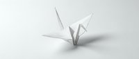 White origami paper crane on clean background symbolizing peace, hope and Japanese art tradition for meditation and mindfulness concepts.