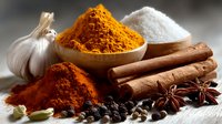 Aromatic spices and seasonings arrangement with turmeric, salt, cinnamon sticks, star anise, garlic, cardamom pods, and peppercorns on wooden surface.