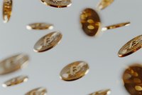 Golden bitcoin coins falling and floating on light background, cryptocurrency concept with selective focus and motion blur effect for financial design.