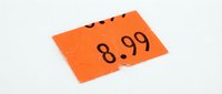 Orange price tag sticker showing 8.99 value on white background, retail pricing label for store merchandise and commercial sales promotion.
