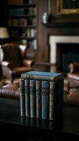 Stack of antique leather-bound books on dark table in classic library setting with fireplace, leather armchair, and bookshelves in soft-focused background for interior design and literature themes.