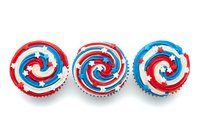Patriotic spiral lollipops with red, white and blue swirl pattern, isolated on white background for candy, confectionery and holiday designs.