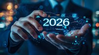 Businessman holding digital 2026 projection with futuristic data visualization and graphs, showing business analytics and technology trends against bokeh lights.