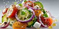 Fresh Mediterranean salad with colorful tomatoes, cucumber, red onion, feta cheese and herbs sprinkled with seasoning on white background.
