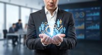 Professional businessman holding glowing digital people icons representing human resources management and team leadership in modern office environment.
