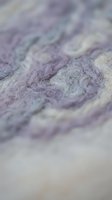 Close-up of lavender and cream ornamental damask textile pattern with soft focus, suitable for fabric design, interior decoration, and upholstery projects.