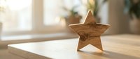 Wooden star decoration on table in bright modern interior with natural sunlight creating warm atmosphere for home decor and crafting projects.