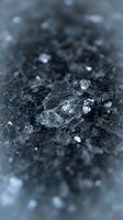Raw coal chunks and fragments scattered on dark surface with shallow depth of field creating industrial mining energy concept for business presentations.