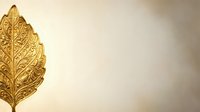 Golden ornate leaf with intricate carved details on neutral beige background for luxury design projects and elegant decorative applications.