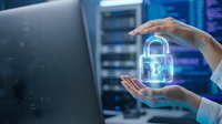Hands holding glowing digital padlock symbol in server room environment, representing cybersecurity, data protection, and network security solutions for business technology.