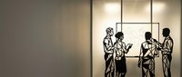 Business professionals discussing project in modern office meeting room with natural lighting and contemporary interior design.