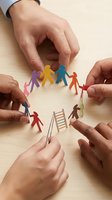 Diverse paper cutout figures arranged in circle with ladder, multiple hands positioning colorful characters on wooden surface for teamwork and collaboration concepts.