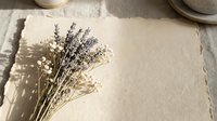 Dried lavender and baby's breath flowers on textured paper with soft shadows, natural botanical arrangement for spa, wellness and aromatherapy concepts.