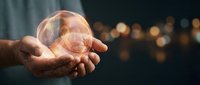 Elderly hands holding glowing transparent sphere with warm bokeh lights in background symbolizing hope, wisdom, protection and spiritual energy.