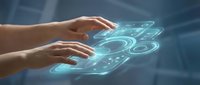 Hands interacting with glowing holographic digital interface displaying futuristic technology symbols and data visualization elements in blue light.