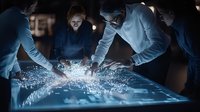 Business team analyzing digital data visualization on interactive touchscreen table with glowing blue interface displaying network connections and analytics.