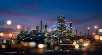 Industrial oil refinery plant with digital network connections at twilight showcasing smart factory technology and industrial automation systems.