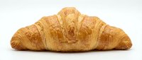 Fresh golden croissant with flaky layers isolated on white background for bakery menu design and culinary projects.