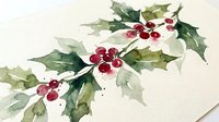 Watercolor holly branches with red berries on textured paper background for Christmas holiday decorations and seasonal greeting cards.